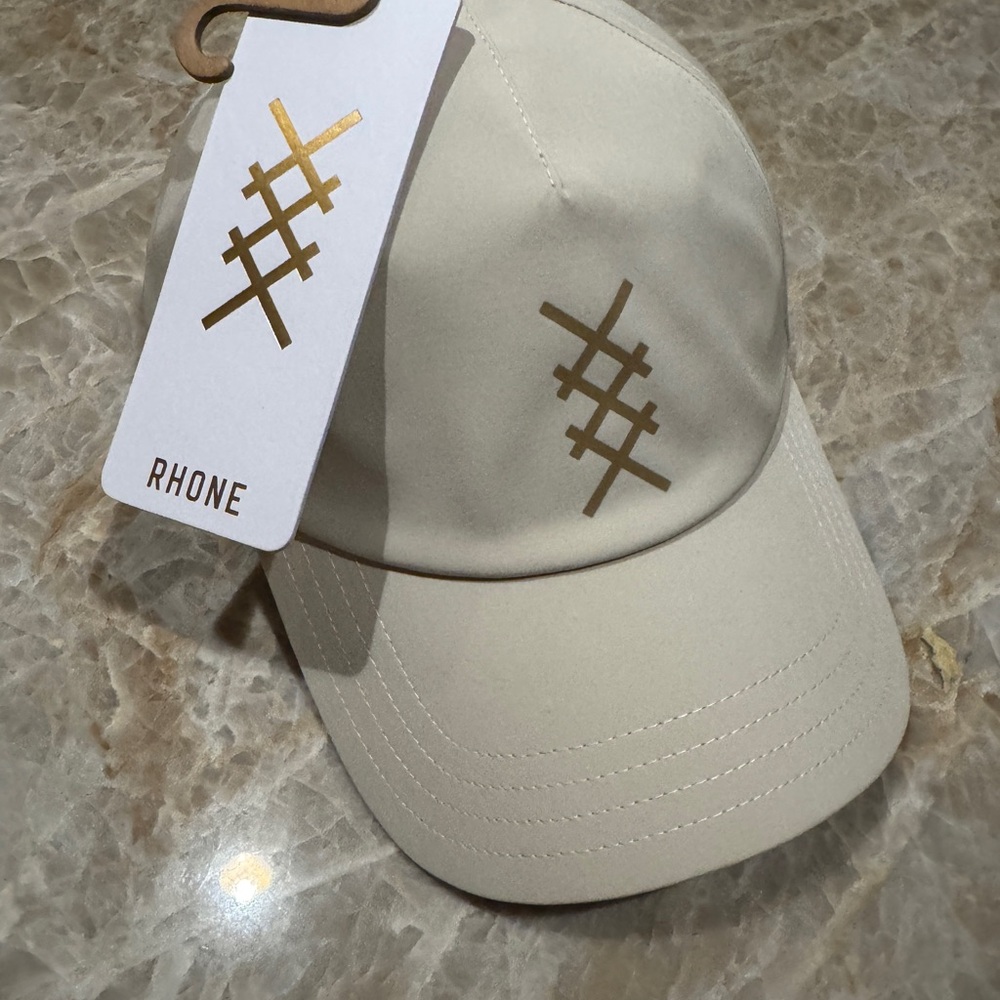 RHONE Cream Baseball Cap with Gold Logo